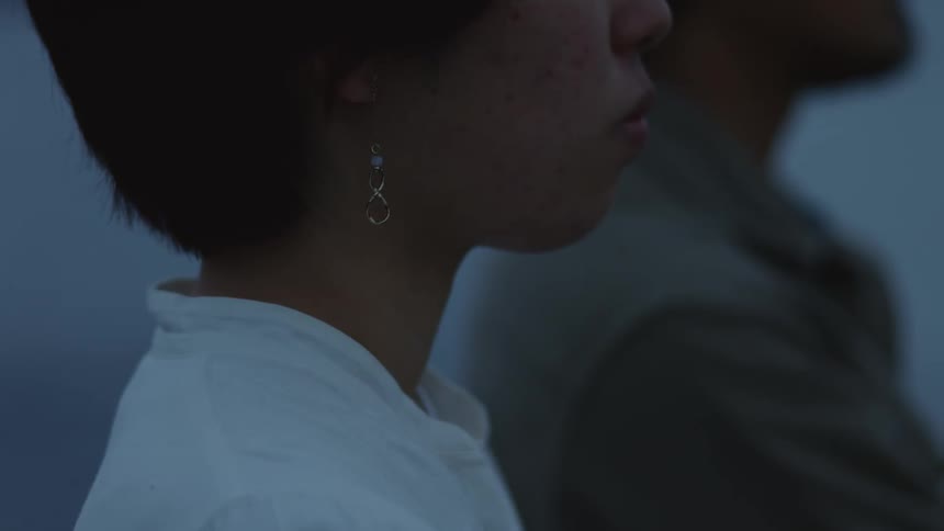 Man and woman cluster together an look the same direction