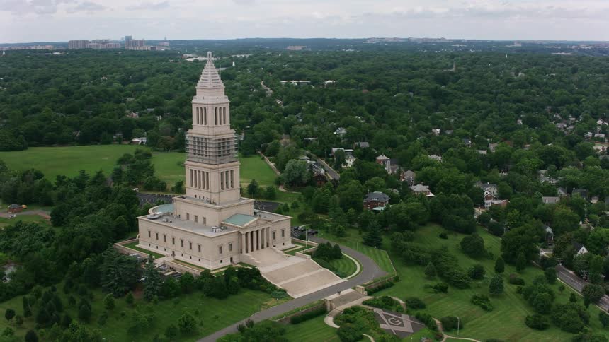 A tower church at the top of a hill overlooking a town