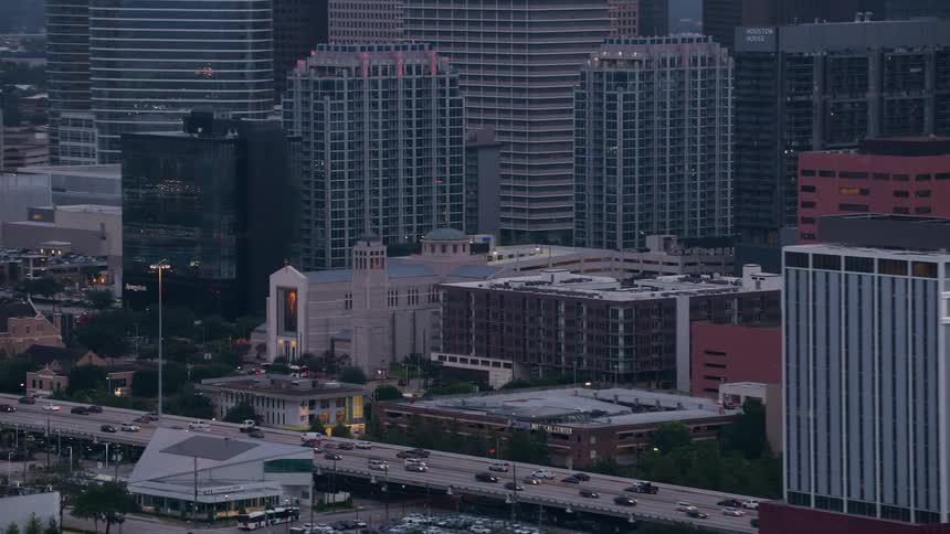 Traffic flows along elevated highway passing churches in city downtown