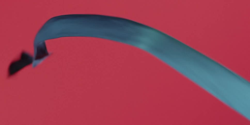 Blue ribbon floating on a red background