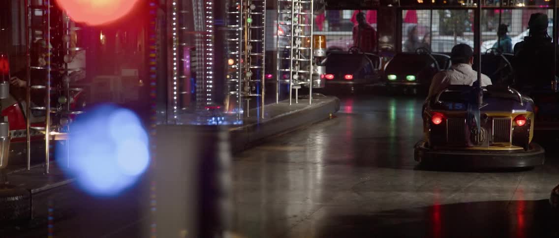 Bumper cars in an arcade has people playing in them