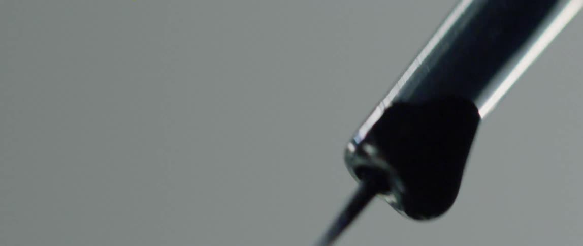 A tattoo needle moving up and down