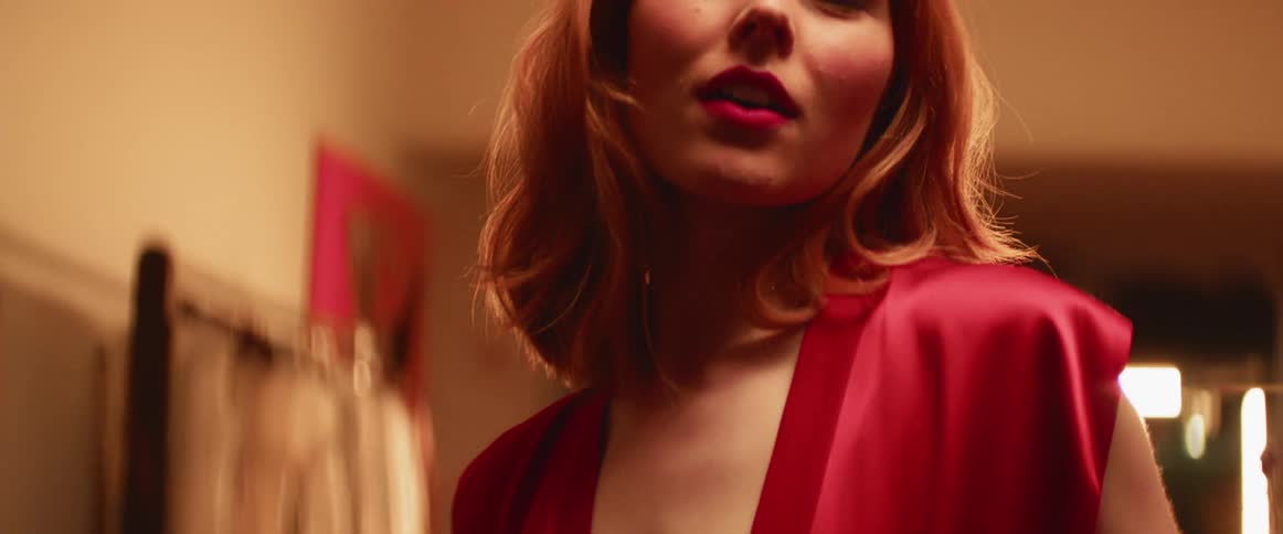 Woman poses in a room at night