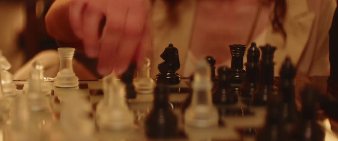 A woman plays a game of chess