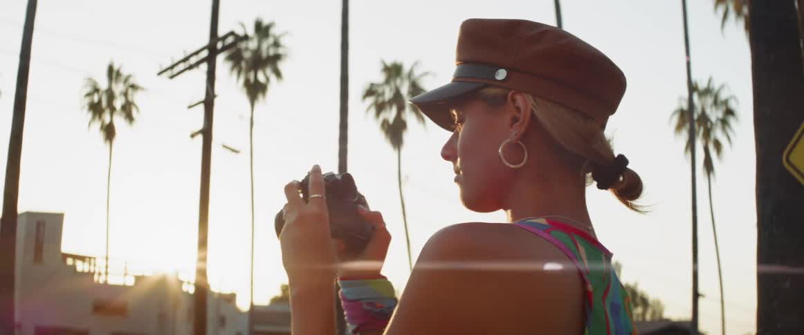 A woman takes a photo outside