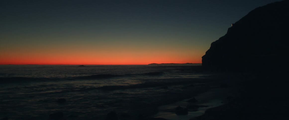 Orange skies at sunset over a beach