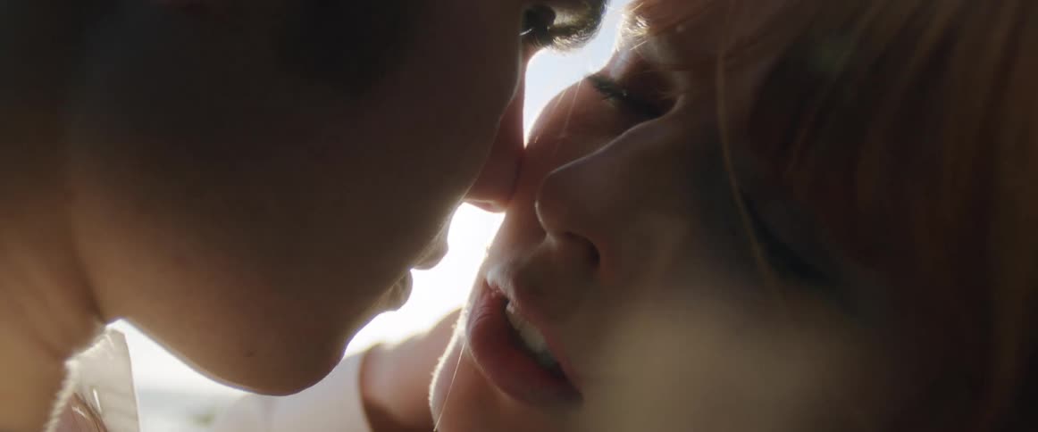A man and woman rubbing their noses on one anothers faces