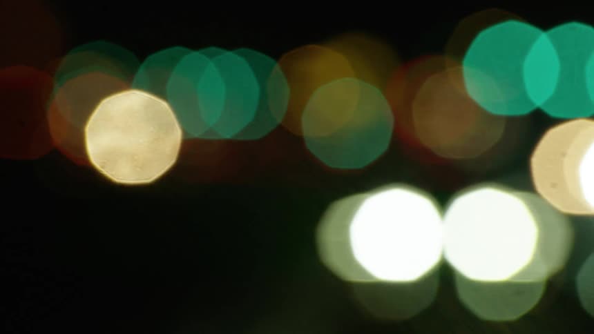 Orbs of colorful light glowing in darkness