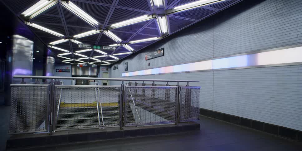 Empty lit building with fence around stairs
