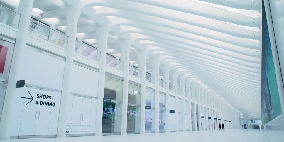 A sign directs customers down a long corridor that leads to stores and restaurants