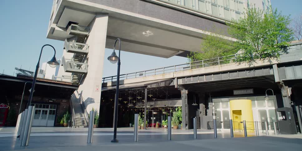 Tall building with shops underneath in city downtown at day