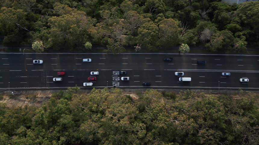 Top down aerial view of cars driving on a freeway at morning
