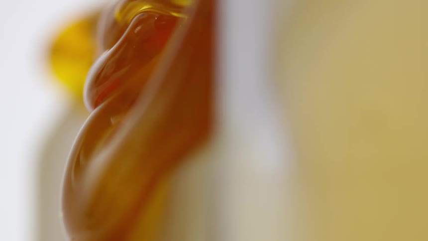 Amber honey flows down side of creamy dessert