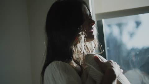 Mother holds newborn baby wrapped in blanket