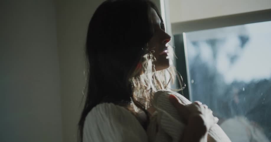 Mother holds newborn baby wrapped in blanket