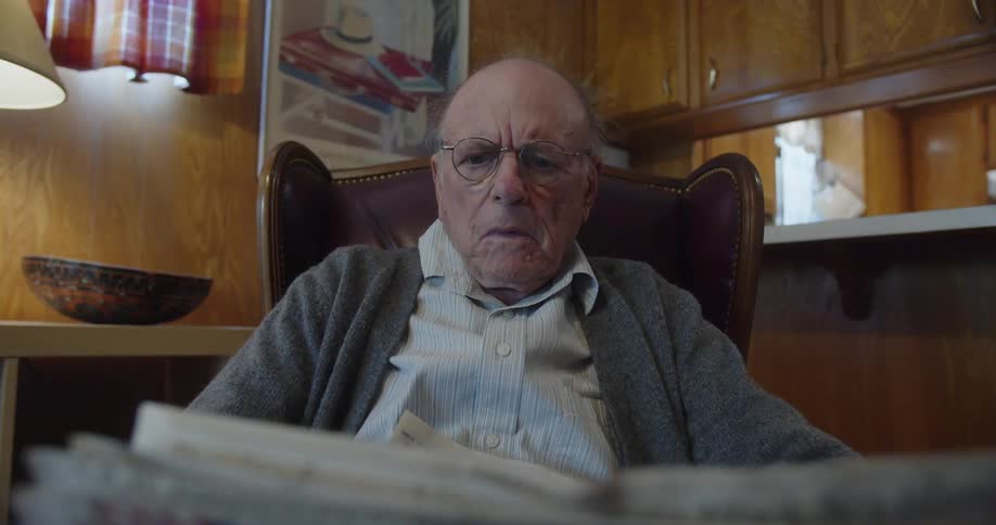An old man reading a newspaper