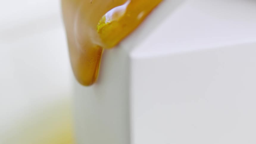 Liquid caramel oozing over a white block