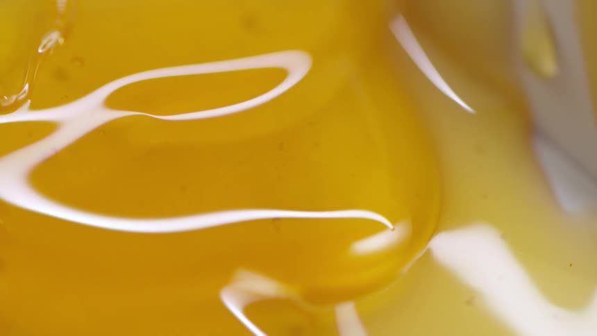 Honey oozing over a white surface