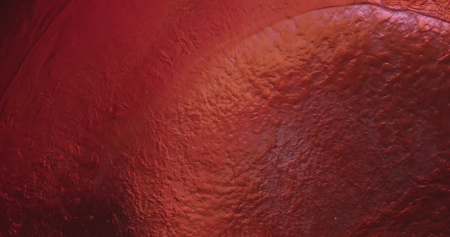 A red liquid rippling in a circle