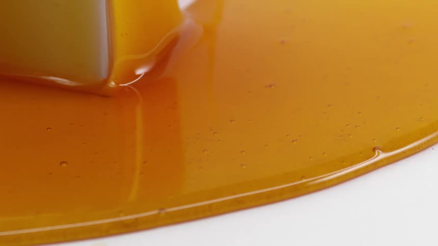 Caramel covers a slice of cheesecake