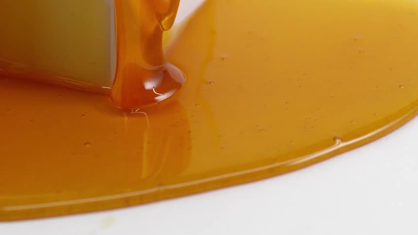 Honey slowly oozing down to make a puddle