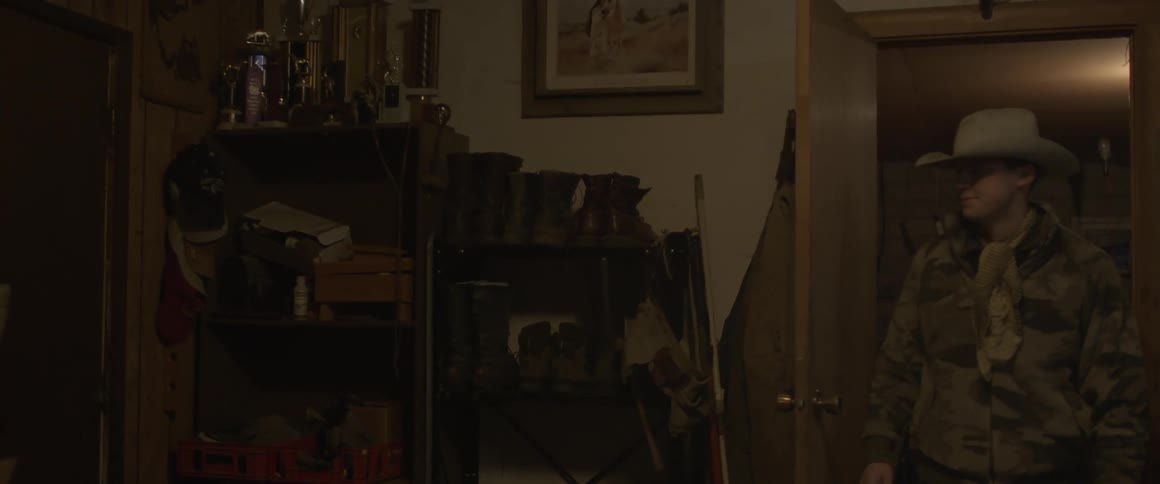 The light comes on and a man enters a room