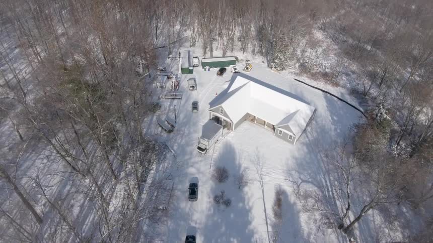 New home construction in a heavily wooded area during the winter