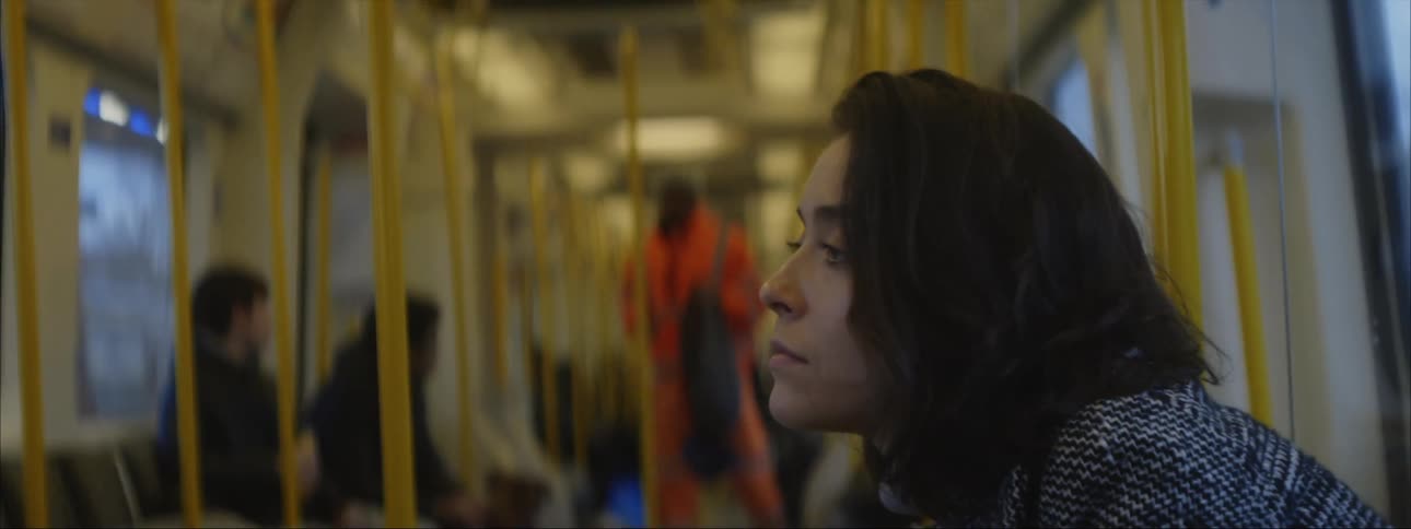 A sad woman riding the subway