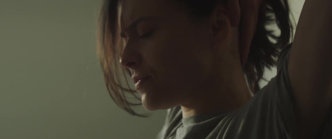 A young woman is inside of her home and is just waking up