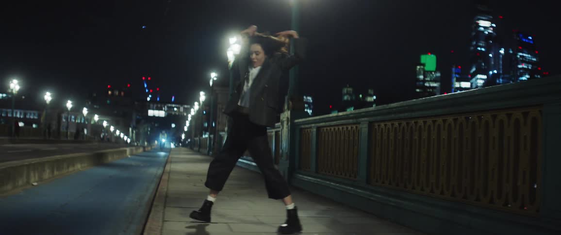 The view is of a young woman that is dancing at night time