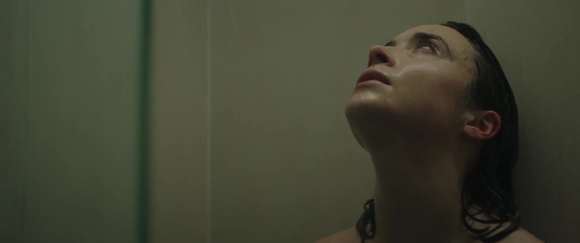 A young woman is taking a shower inside of her home