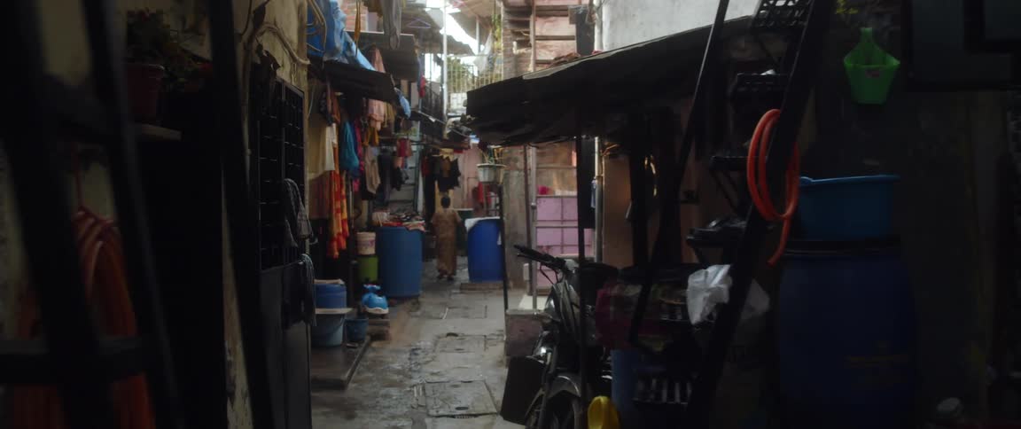 A woman walks down a street filled with shops
