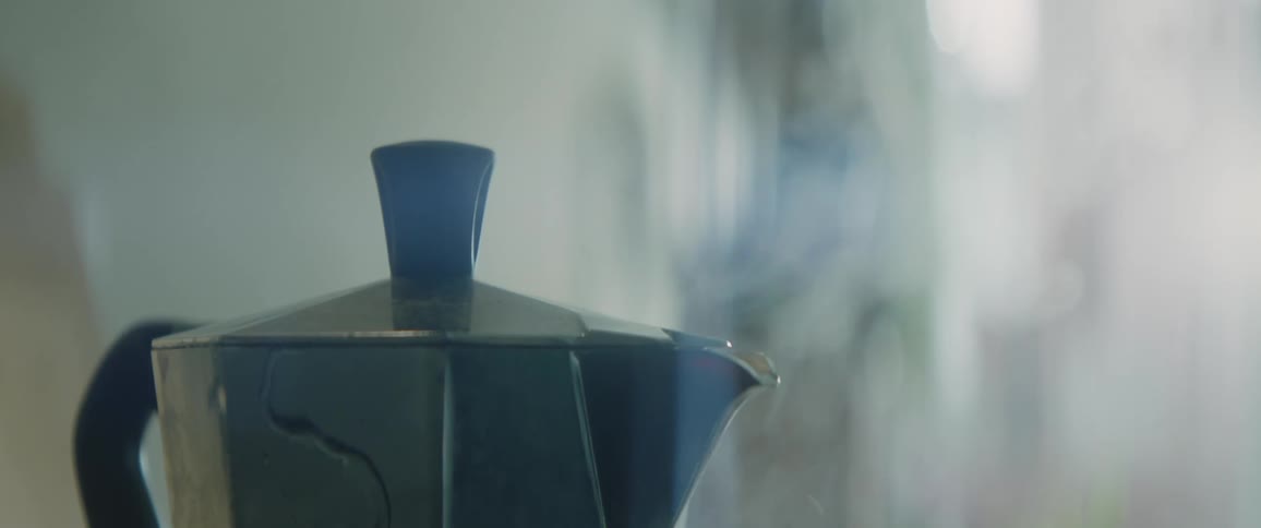 The view is of a tea pot in a room around day time