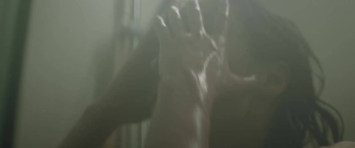 Woman takes a shower in the bathroom