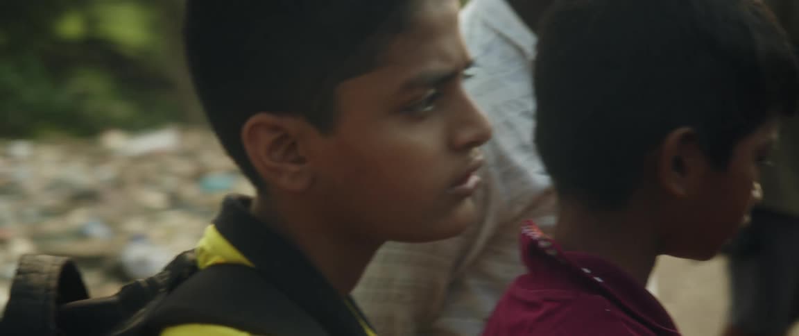 Children are looking at something in town