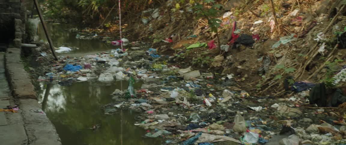 Area behind a house that is covered in trash and dirty water the aftermath of flood or hurricane