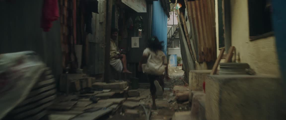 Two young girls run through an indian alley