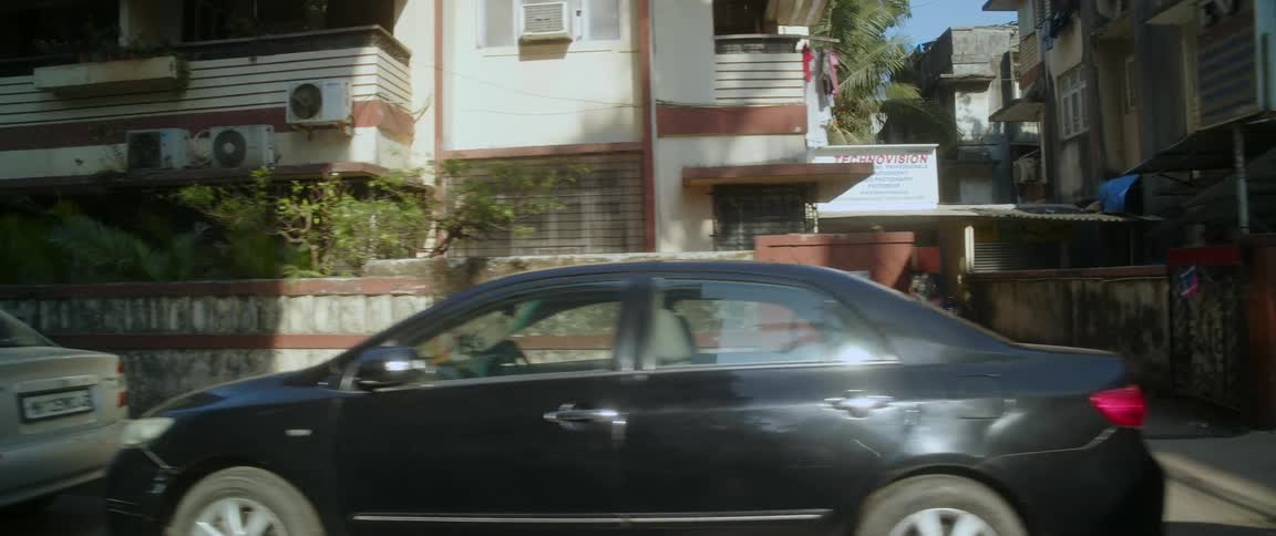 Cars parked at the front of houses and apartments in the city at morning
