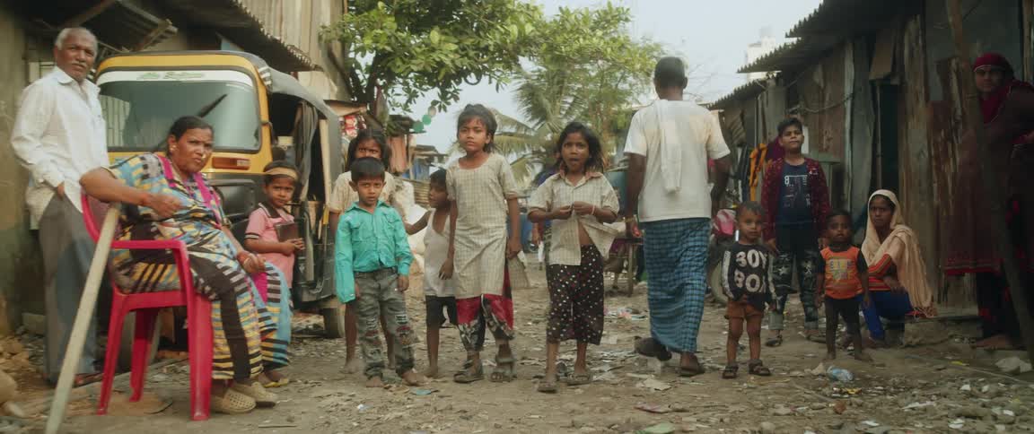 Drone view of children teenagers and adults in a roadway in a third world country