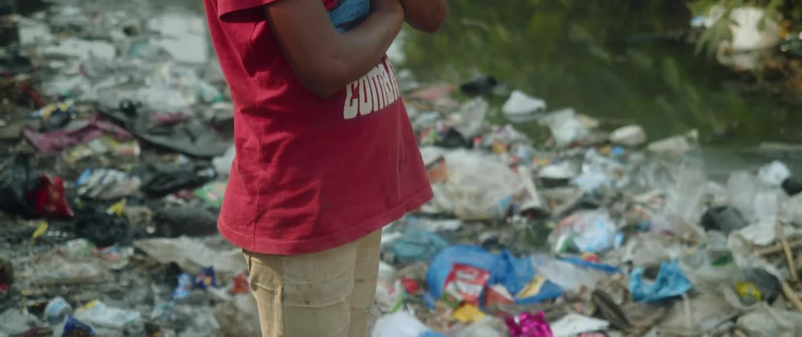 The view is of a young kid that is outdoors and looks sad