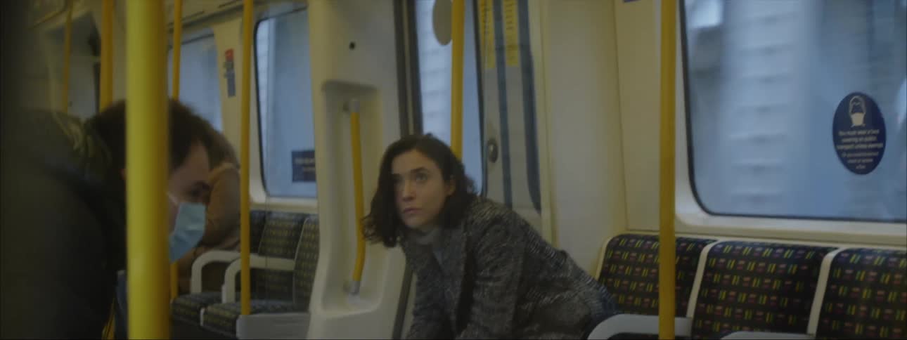 Young bored woman sits in a subway car looking around