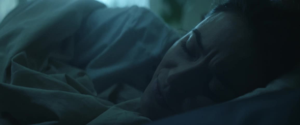 Close up of the face of a young woman waking up in her bed at morning