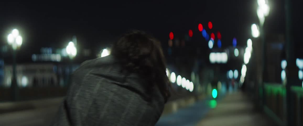 A woman dances on a downtown sidewalk