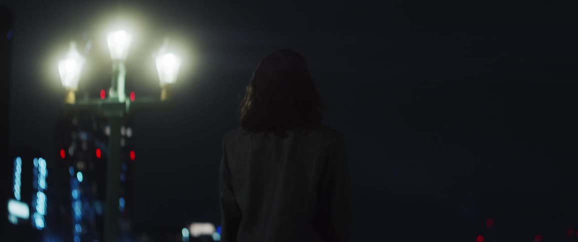 Young woman starts dancing on the city streets at night