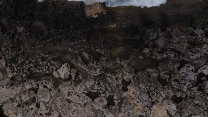 A view of the ocean tide near the coast is displayed
