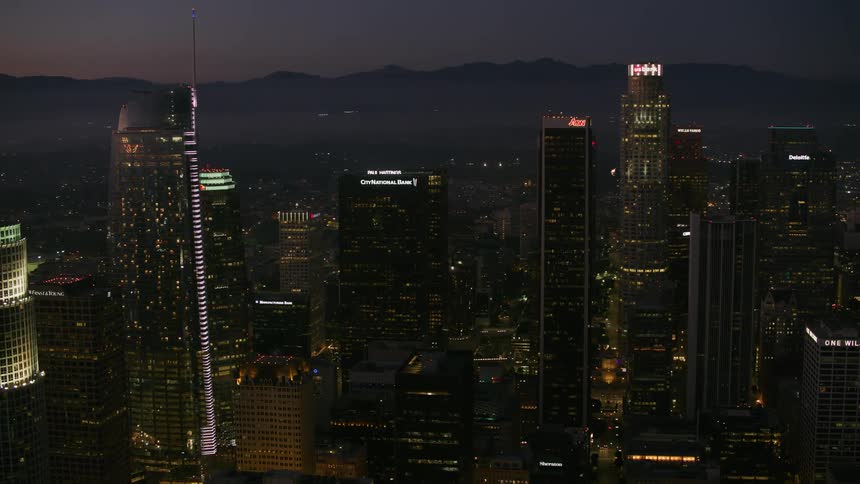 Heavy traffic drives along highway through city at night