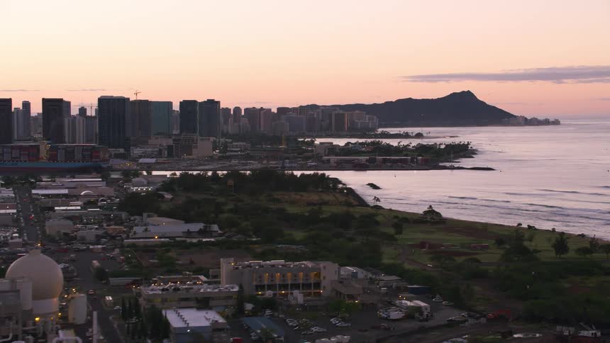 An arquipelago with a city factories and mountains at dawn