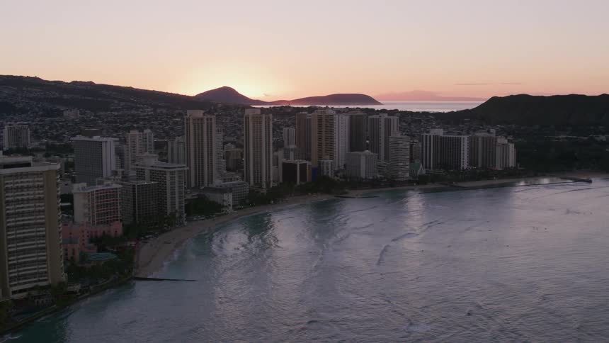 A metropolitan tower block between the ocean and a hill