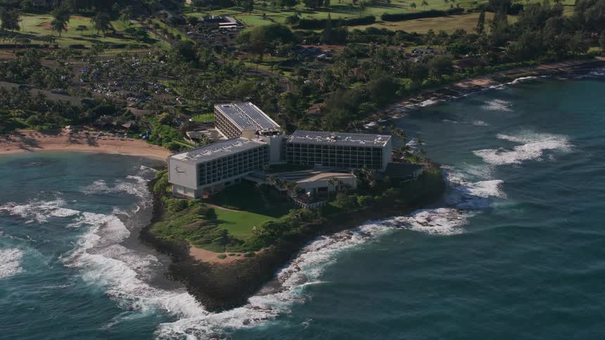 A building complex with three identical buildings filling a small peninsula