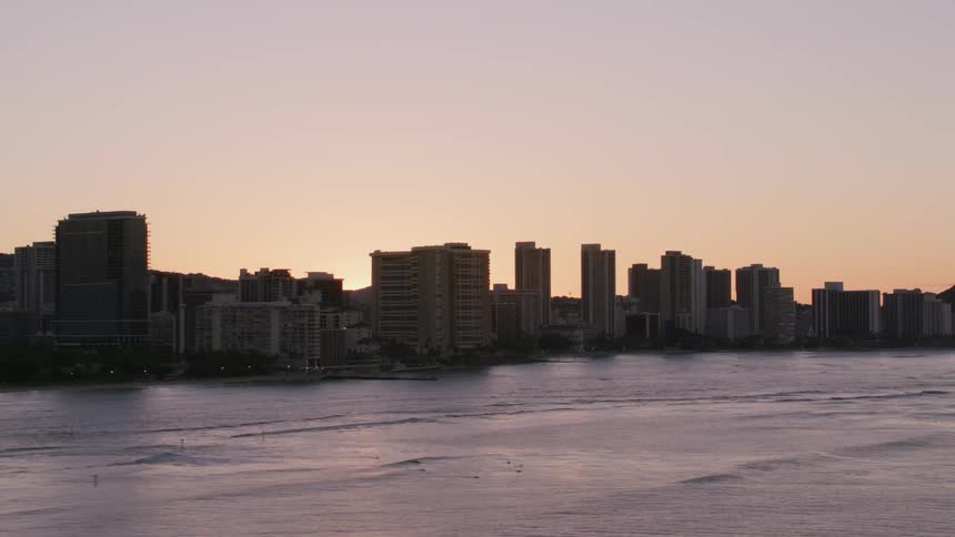 Aerial view of a city near the ocean water is displayed